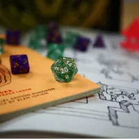 photo of a green 10-sided dice on a Dungeons and Dragons game board