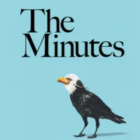 An image of a crow with an eagle mask tied around it's head.