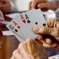 a pair of hands holding playing cards