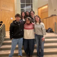 Group standing at college entrance. 
