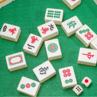 Mah Jongg tiles spread across a green playing surface