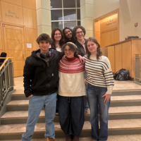 Group standing at college entrance. 